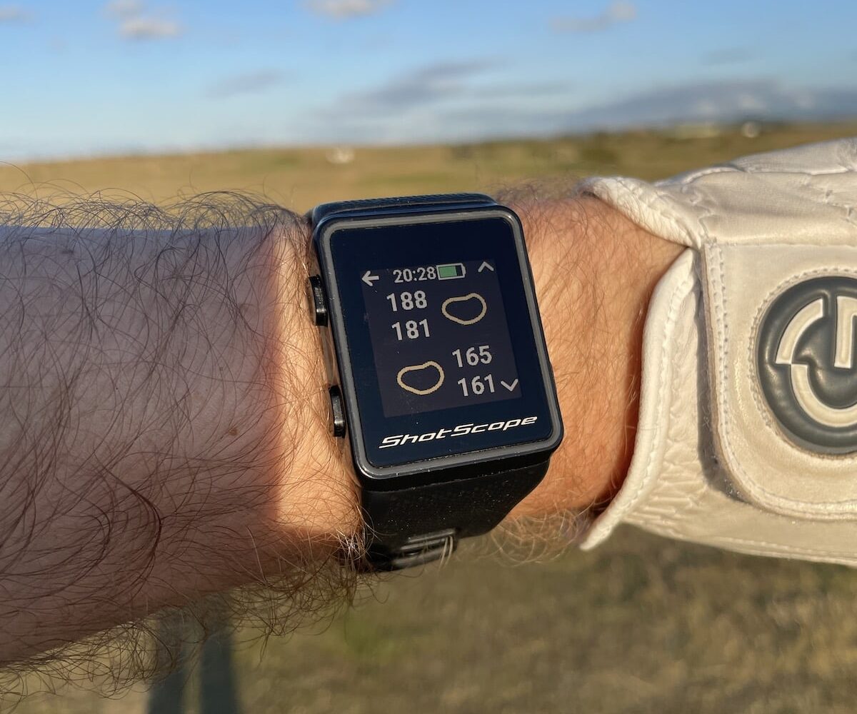 Shot Scope V3 golf watch on a man's wrist showing hazard screen close up