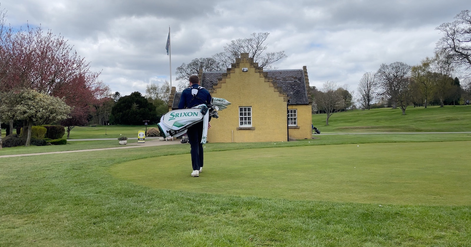 andy carrying golf bag