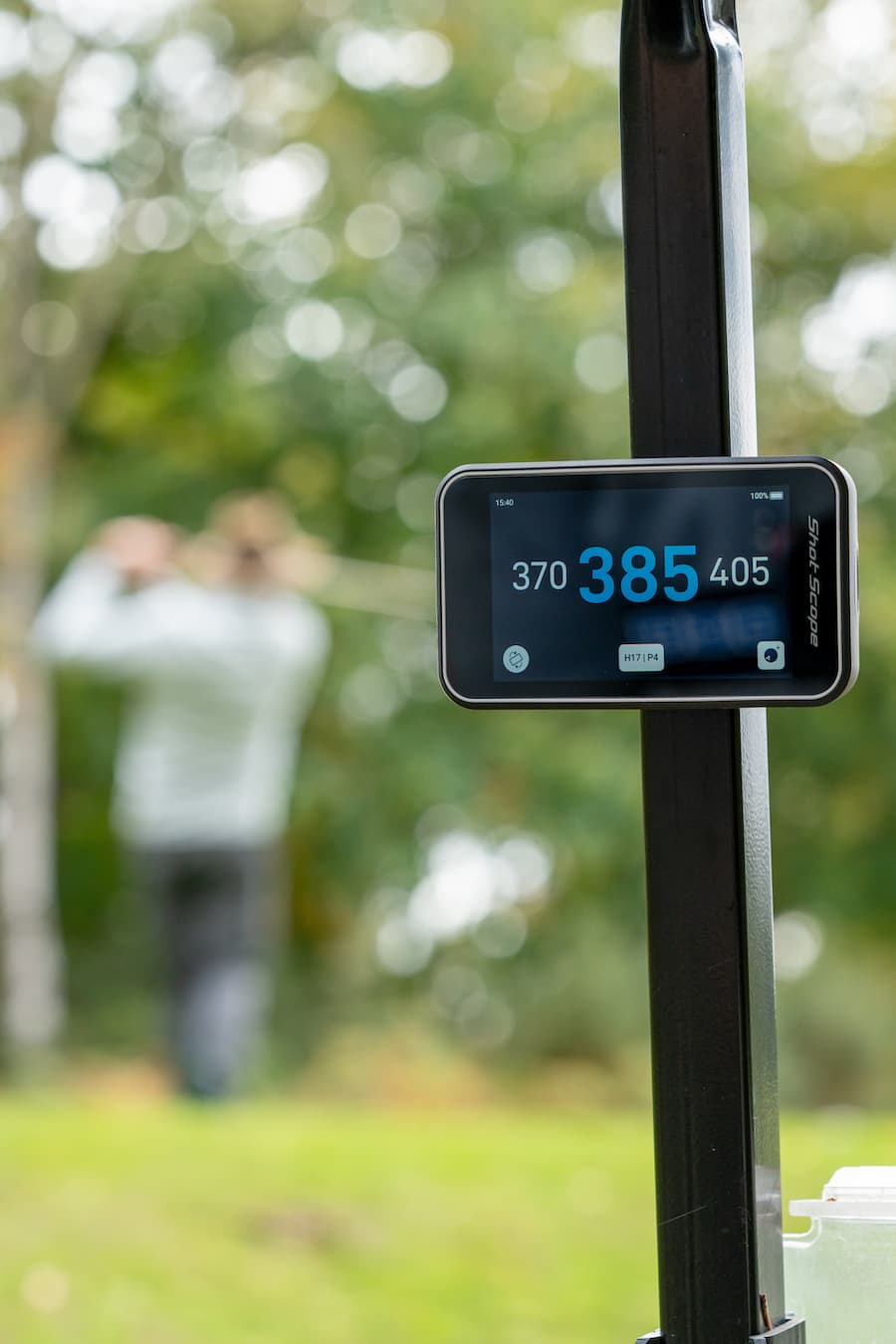 Shot Scope H50 Handheld on the golf course, mounted on a cart using the cart magnet