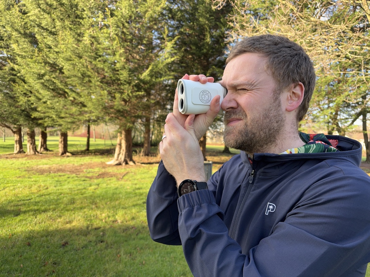 Andy looking through the Shot Scope PRO X laser rangefinder on the golf course.