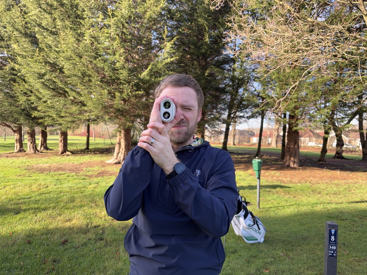 Andy looking through the Shot Scope PRO X laser rangefinder directly at the camera.