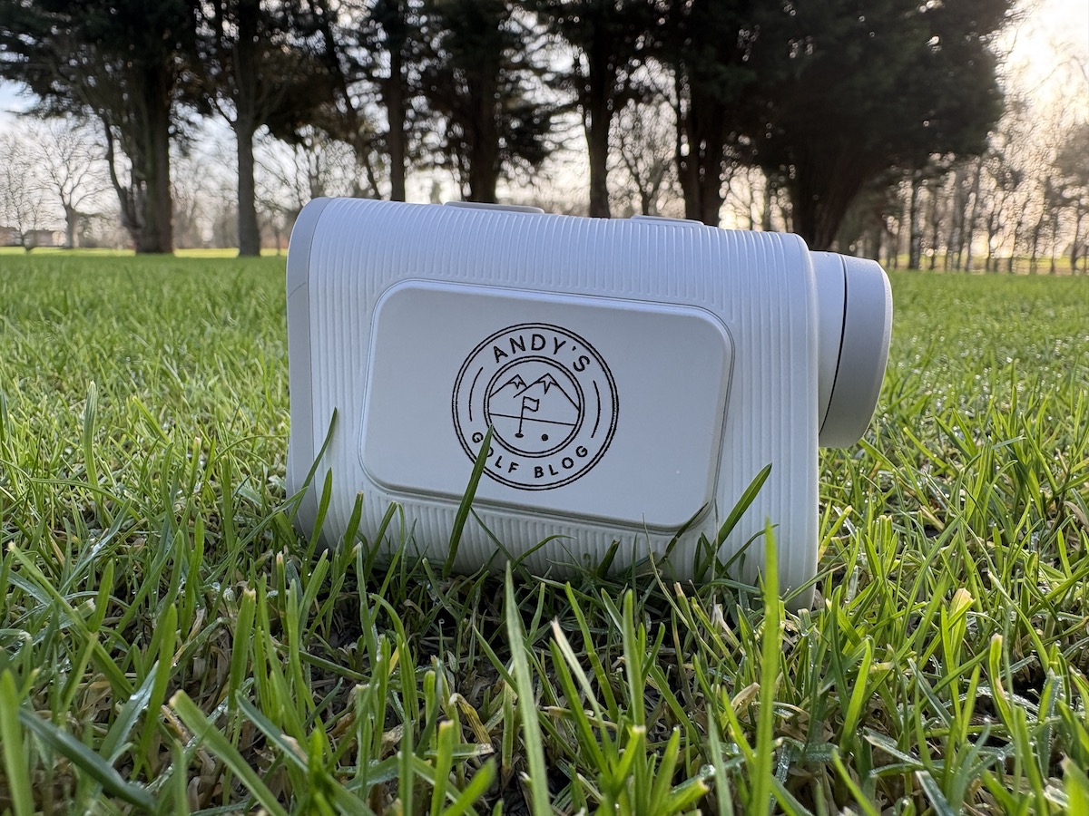 Shot Scope PRO X laser rangefinder sitting on the grass on the golf course.