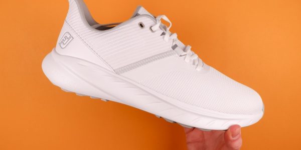 FootJoy Flex men's golf shoes on an orange background